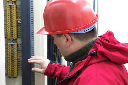 Engineer in red control wiring  in power plant