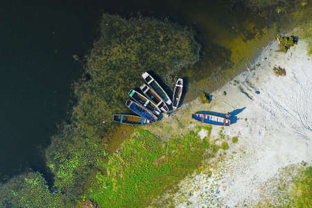 Aerial top view of a group of  colorful fishing boats and fishermanの写真素材