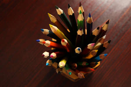 Group of colored pens in wooden table, Top view  の写真素材
