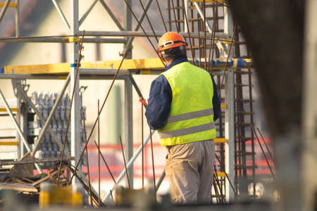 Worker in orange helmet at the construction siteの写真素材