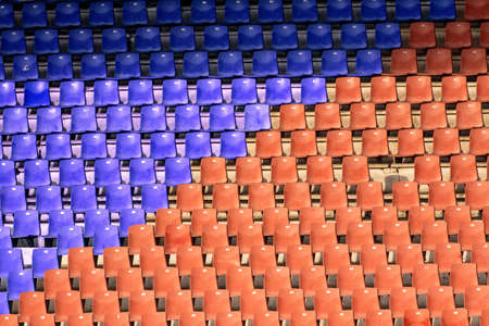 Red and blue empty seats at the football stadiumの写真素材