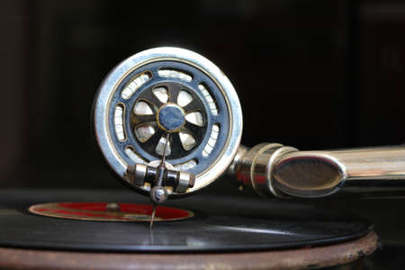 Old gramophone head and disc on the blackの写真素材