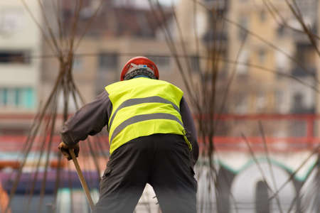 Builder in red hardhat at the construction site