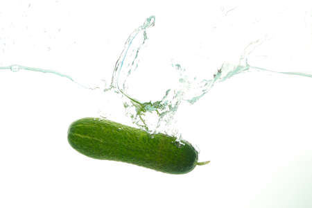 Green Cucumber in water splash on whiteの写真素材