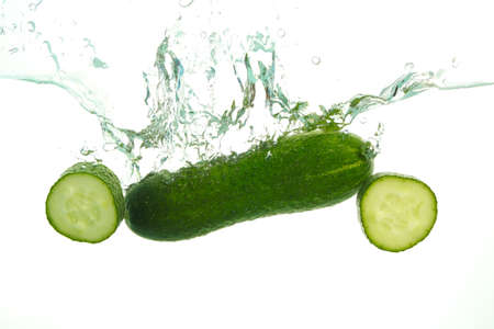 Green Cucumber in water splash on white backgroundの写真素材