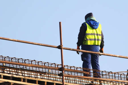Worker at the construction site ower blue sky