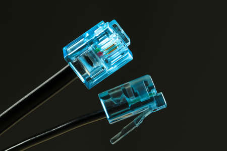 Two cables with blue rj-45 connector on blackの写真素材