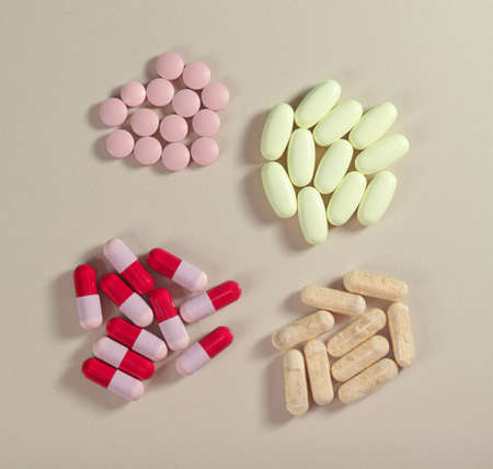 Top view of four group of colorful capsules and pills