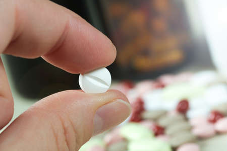 Man takes the white antidepressants tablets