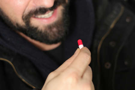 Man takes ecstasy pills in the partyの写真素材