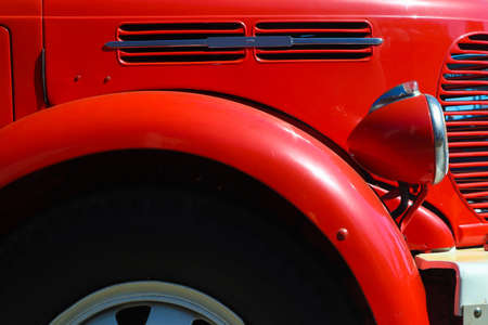 Detail of red vintage firetruck tires, light, fender and cooler