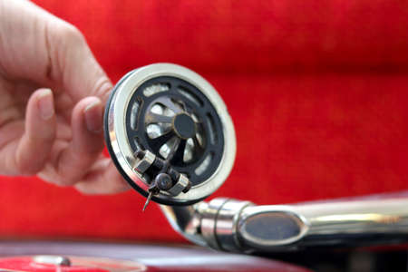Dj plays a red record on an old gramophone