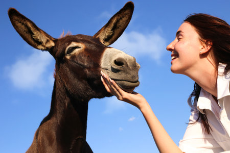 Portrait of Best Friends, Young Girl and  brown tame Donkeyの写真素材