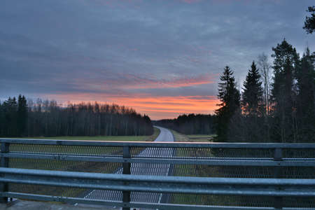 Sunrise and motorway autumnal morning.の写真素材