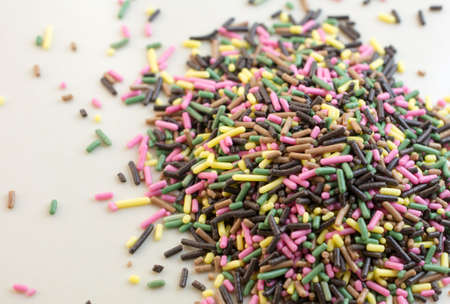Colorful nonpareils on a white plate.の写真素材