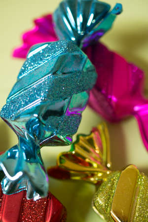 Different colors, plastic candy ornaments with lime green backgroundの写真素材