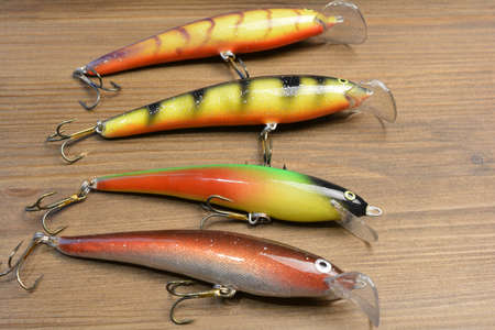 Home made fishing lures, pine wood backgroundの写真素材