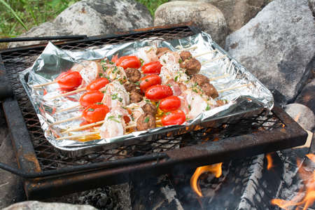 skewers on top of an open fire.の写真素材