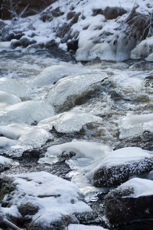 Ice and water. Cold rocks, ice,water and snow.の写真素材