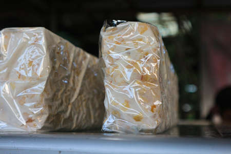 Crispy rice in plastic bag for sale at street food marketの写真素材
