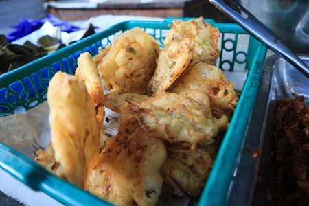 Deep-fried potatoes in a basket on a market in Thailand.の写真素材