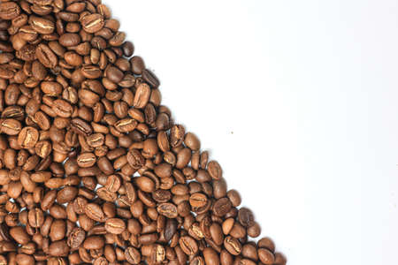 Roasted coffee beans on white background, top view. Space for textの写真素材