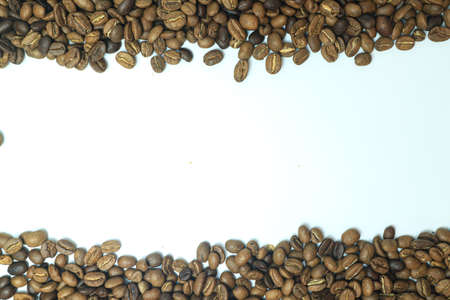 Coffee beans on white background with copy space for text.