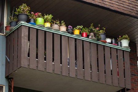 The wooden balcony of an old farm mountain house with colorful flowersの写真素材