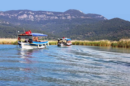Pleasure boats motor up the Dalyan river, Turkeyのeditorial素材