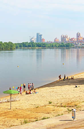 Unidentified people are resting on the beach of Dnipr river in Obolon district, Kyiv, Ukraine  Obolon embankment is a favorite place of people for resting in Kyivのeditorial素材