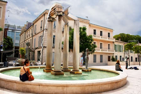 Unidentified tourists near fountain in Nimes, Franceのeditorial素材