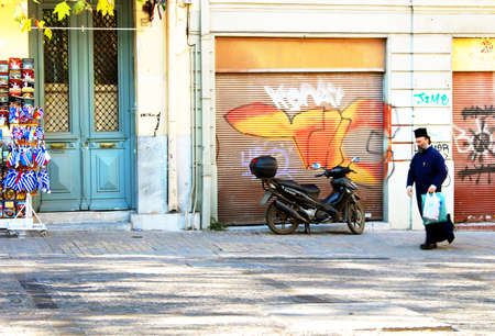 A greek orthodox priest walking down the street in Athens, Greeceのeditorial素材