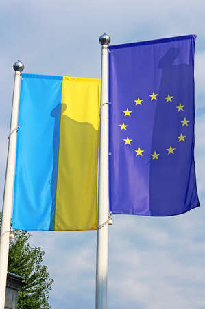 Flags of the EU and Ukraine on the flagpoleの写真素材