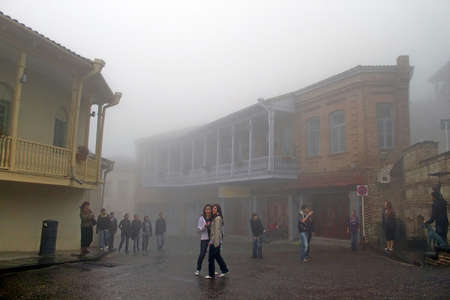 Teenagers are on the excursion in Sighnaghi in foggy weather, Georgia. Sighnaghi is a town in...