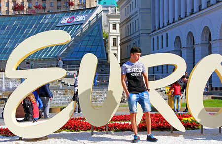 Unidentified tourist near part of official logo of Eurovision Song Contest 2017 on Maidan Nezalezhnosti (Independence Square)のeditorial素材