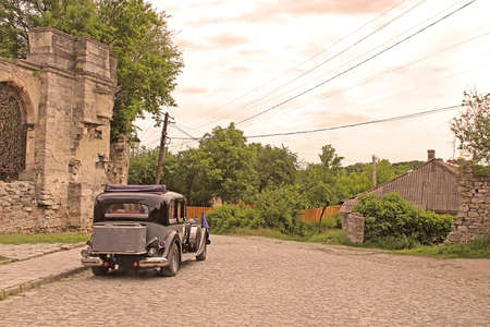 Old car on the street of Kamianets-Podilskyi, Ukraine. Vintage filterの写真素材