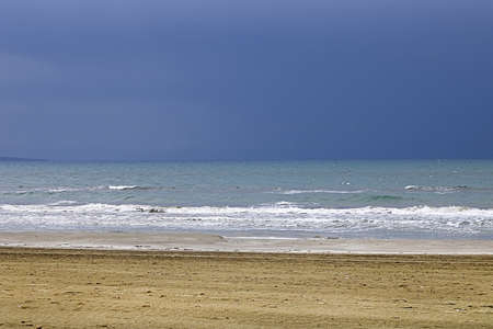 View of Mediterranean Sea with a cloudy blue sky after the rain. Waves and wind in Larnaca beach