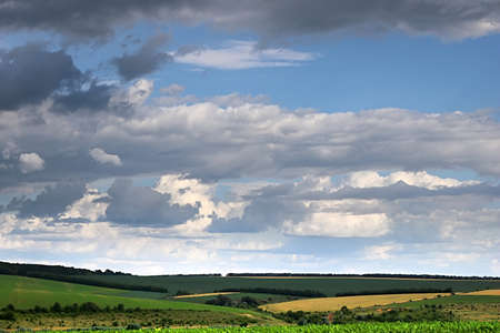 Countryside with fields and cloudy skyの写真素材