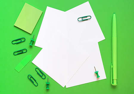 Pen, paper and stationery on a green background. In the green style. The concept of sustainable business. Flat lay, top view. Place for textの写真素材