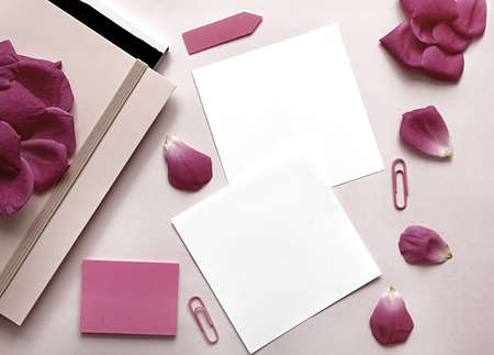 Workplace of woman decorated with pentals of roses. Pink backround. Place for text. Flat lay, top...