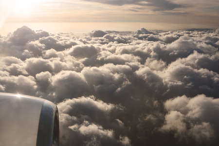 Sky view on the plane. Beautiful sky above clouds with dramatic light in the evening. Cabin view and...