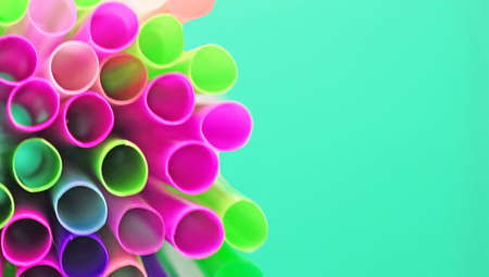 Unusual top view of many multicolored plastic cocktail tubes on blue background. Drinking straws of...