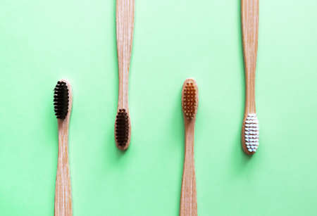 Bamboo toothbrushes on trendy green background. Eco-friendly products. Eco, zero waste and health...