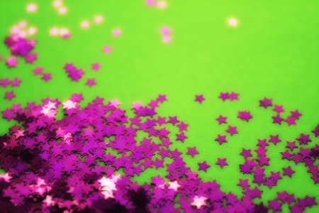 Greenr background with purple glitter stars. Flat lay. Holiday concept. New year timeの写真素材
