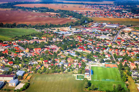 Top view of a village, agricultural field and soccer field near Bratislava, Slovakia. Drone view