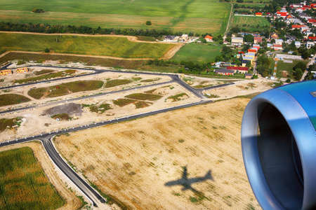 View of the village, agricultural fields from an airplane near Bratislava, Slovakia. Shadow of an airplane on the field.の写真素材