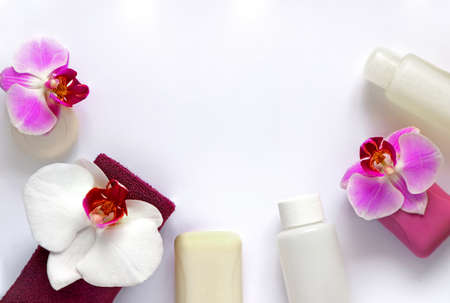 Soap, towel and hygiene product, decorated with white and lilac orchid flowers on a white background. Spa conceptの写真素材