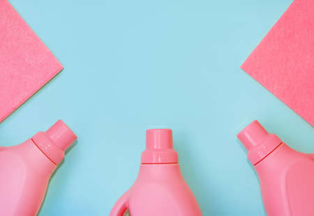Red plastic bottles with chemicals for cleaning, rags for cleaning. Delicate blue background. Cleaning conceptの写真素材