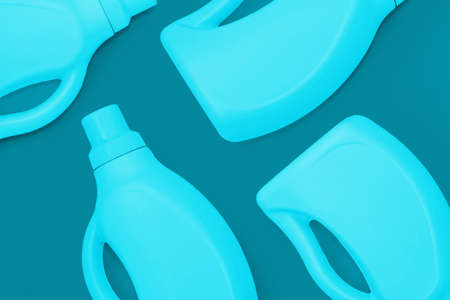 Blue bottles with chemicals for cleaning on a dark blue background. Cleaning conceptの写真素材