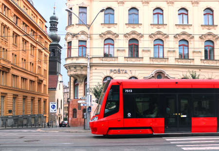 BRATISLAVA, SLOVAKIA - SEPTEMBER 01, 2019: Red tram on SNP square with view of Post office building and Church of the Virgin of Loreto leftのeditorial素材